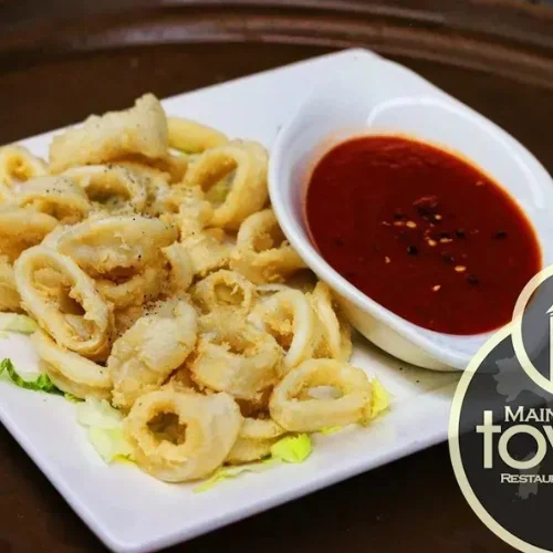 Calamari Fritti - Lightly breaded calamari tossed in olive oil, garlic, and sliced pepperchinis.
