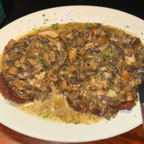 Chicken Marsala - Baked chicken breast sautéed with mushrooms and finished with our own Marsala wine sauce.