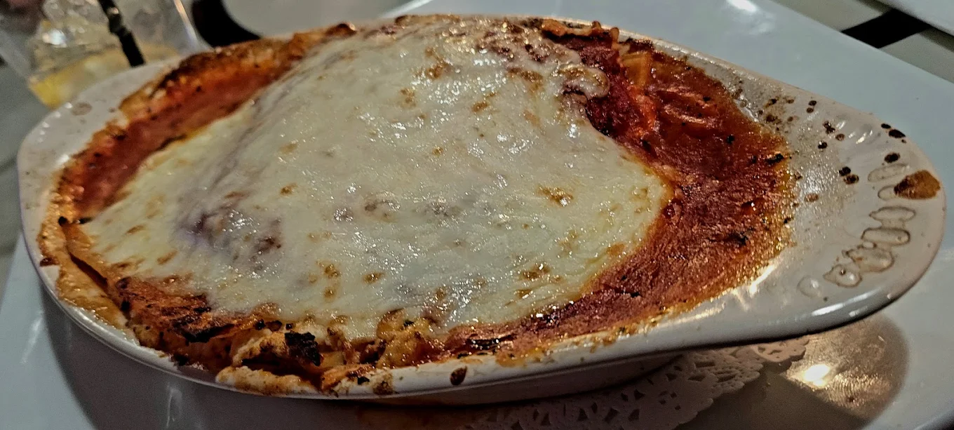 Lasagna - Classic homemade lasagna served with a side salad.